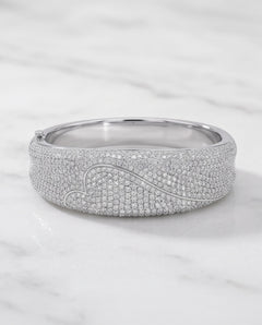 8 carat pavé diamond heart bangle in 18K white gold on marble