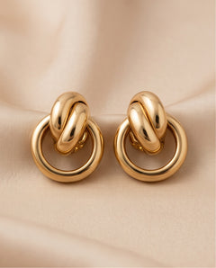 18kt Italian gold interlocking knot earrings, pair on ivory silk