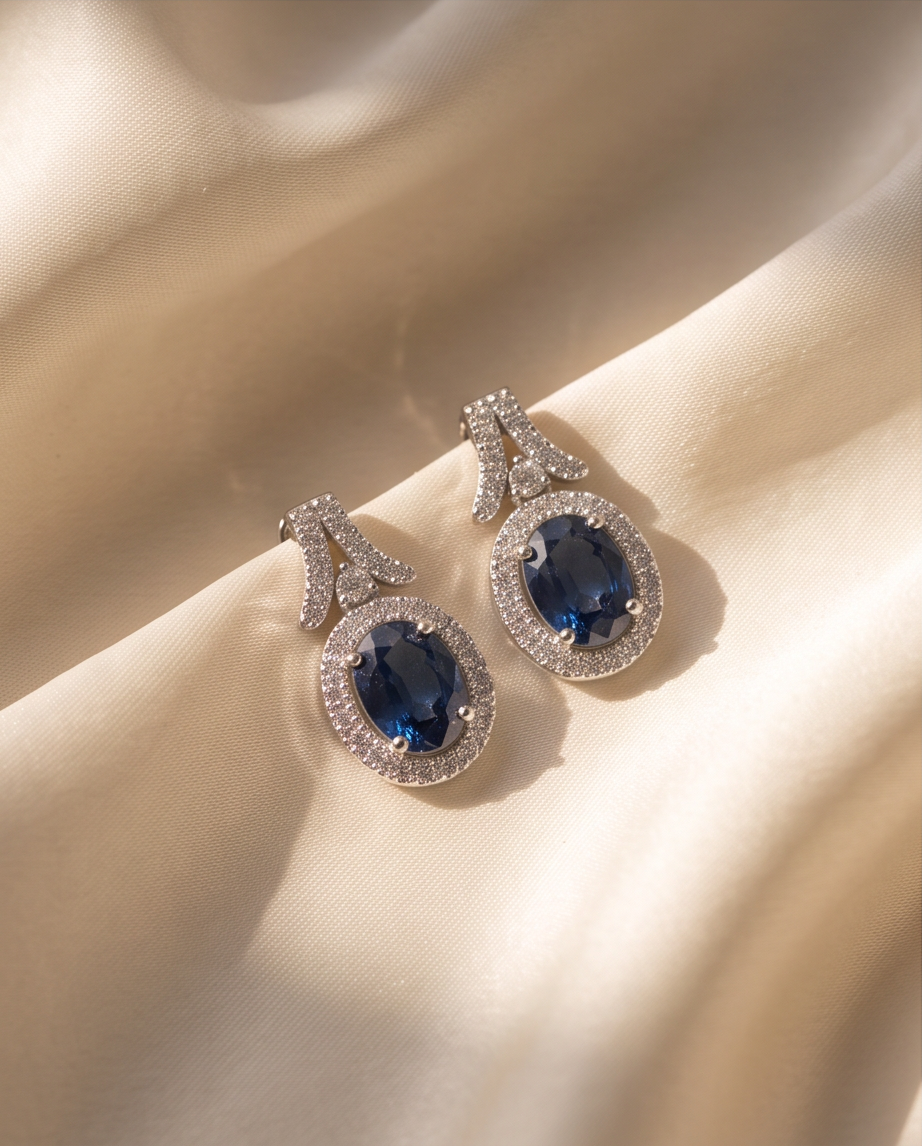 Oval Sapphire & Diamond Halo Earrings in 18kt White Gold