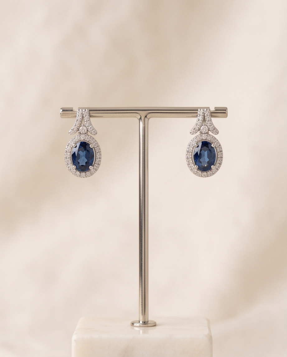 Oval Sapphire & Diamond Halo Earrings in 18kt White Gold
