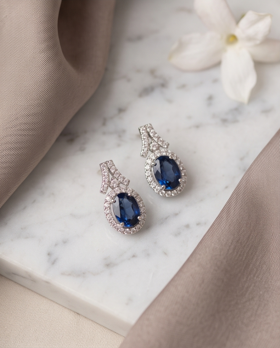 Oval Sapphire & Diamond Halo Earrings in 18kt White Gold