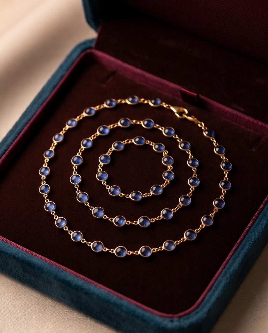 Kyanite and gold station necklace coiled in a velvet presentation box