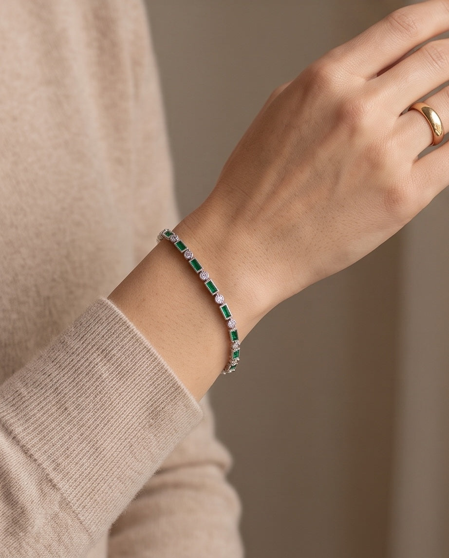 Emerald and diamond line bracelet worn on the wrist