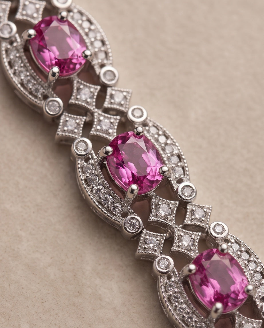Macro detail of oval pink sapphires in milgrain diamond frames