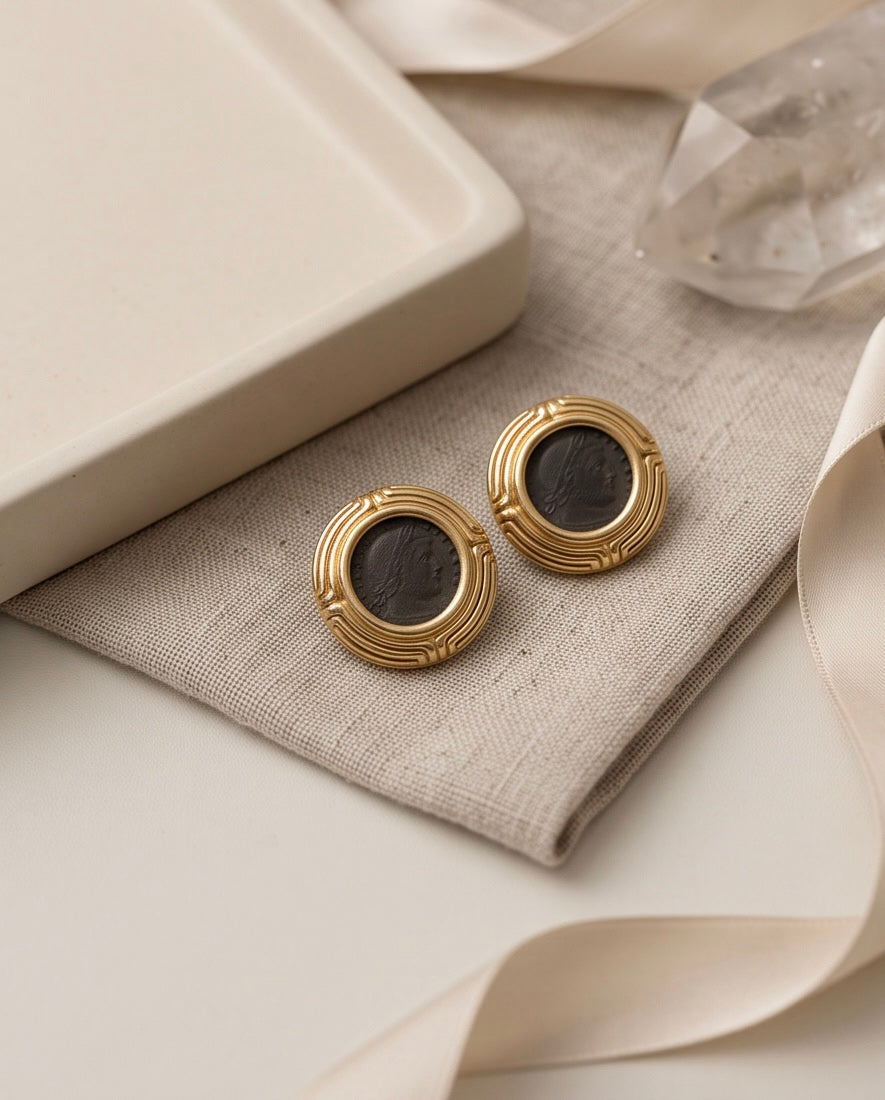Roman coin earrings styled on linen with quartz and silk ribbon