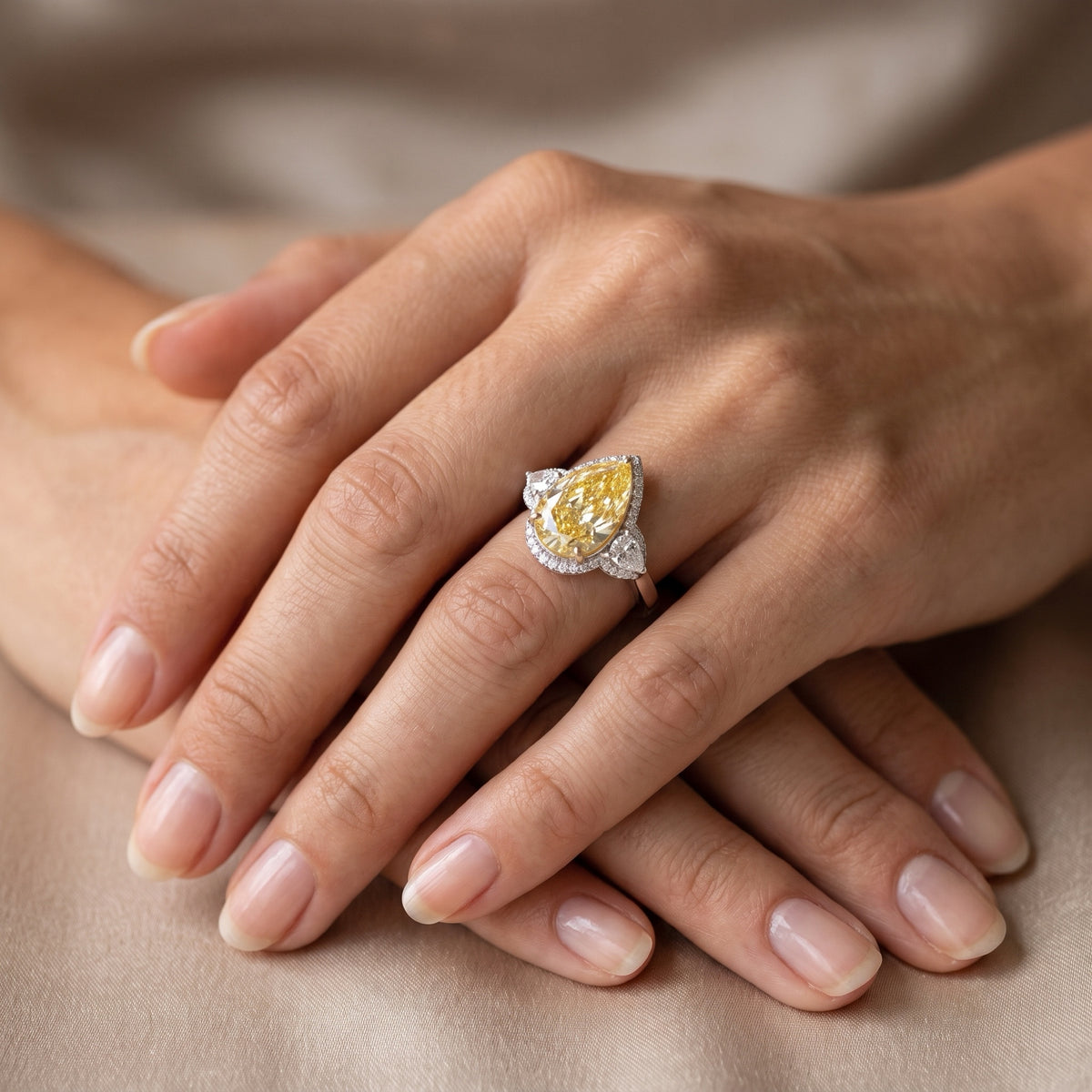 Fancy yellow pear diamond ring worn on the hand