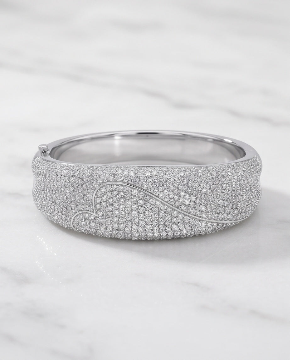 8 carat pavé diamond heart bangle in 18K white gold on marble