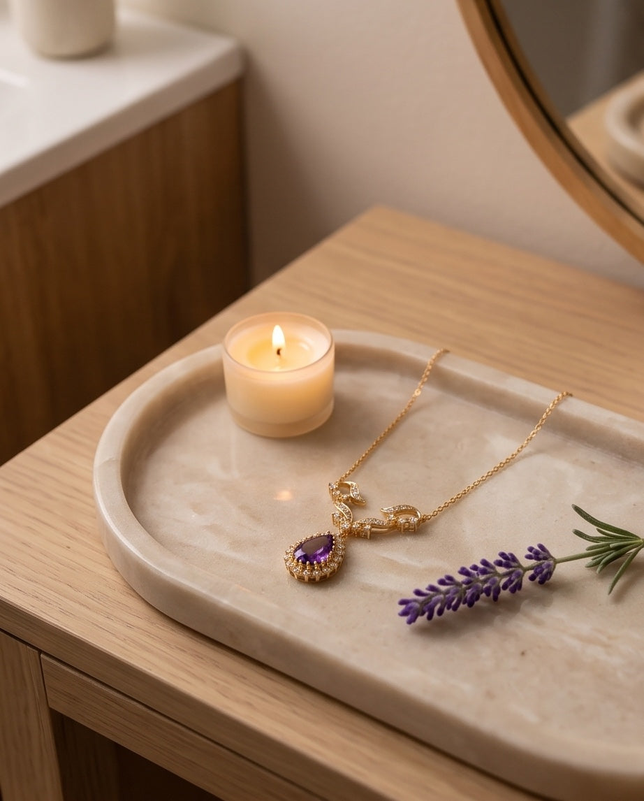 Amethyst and diamond necklace on a marble vanity tray
