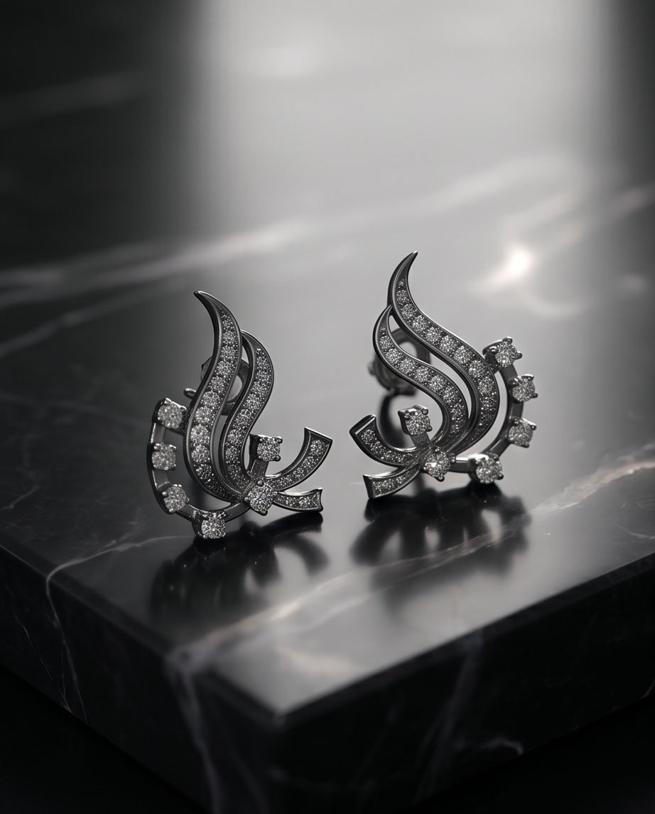 Diamond swirl earrings on black marble