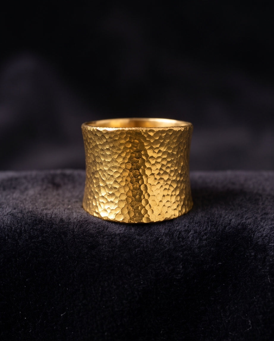 Close-up of hammered texture on 24K gold wide band ring