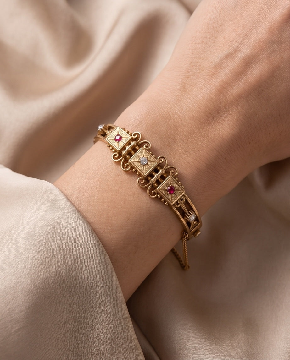 Antique 14kt gold ruby and diamond bangle bracelet worn on wrist