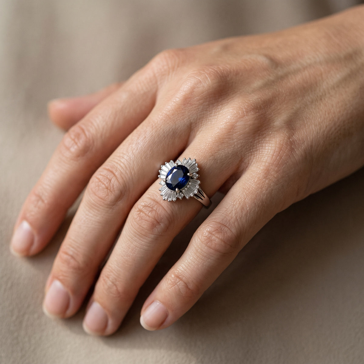Platinum blue sapphire ballerina diamond ring worn on hand