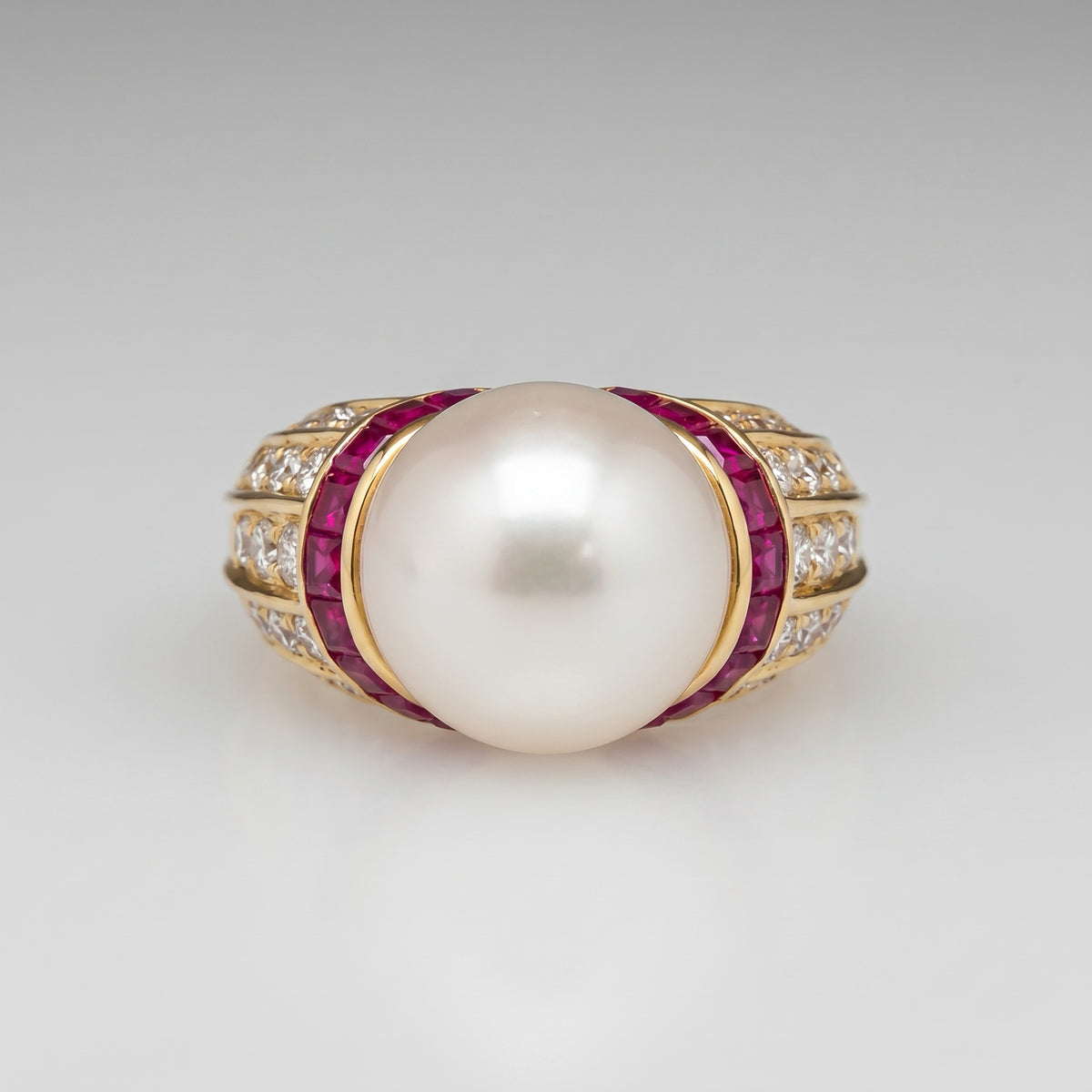Front view of the 18K gold South Sea pearl ring with ruby and diamond bands