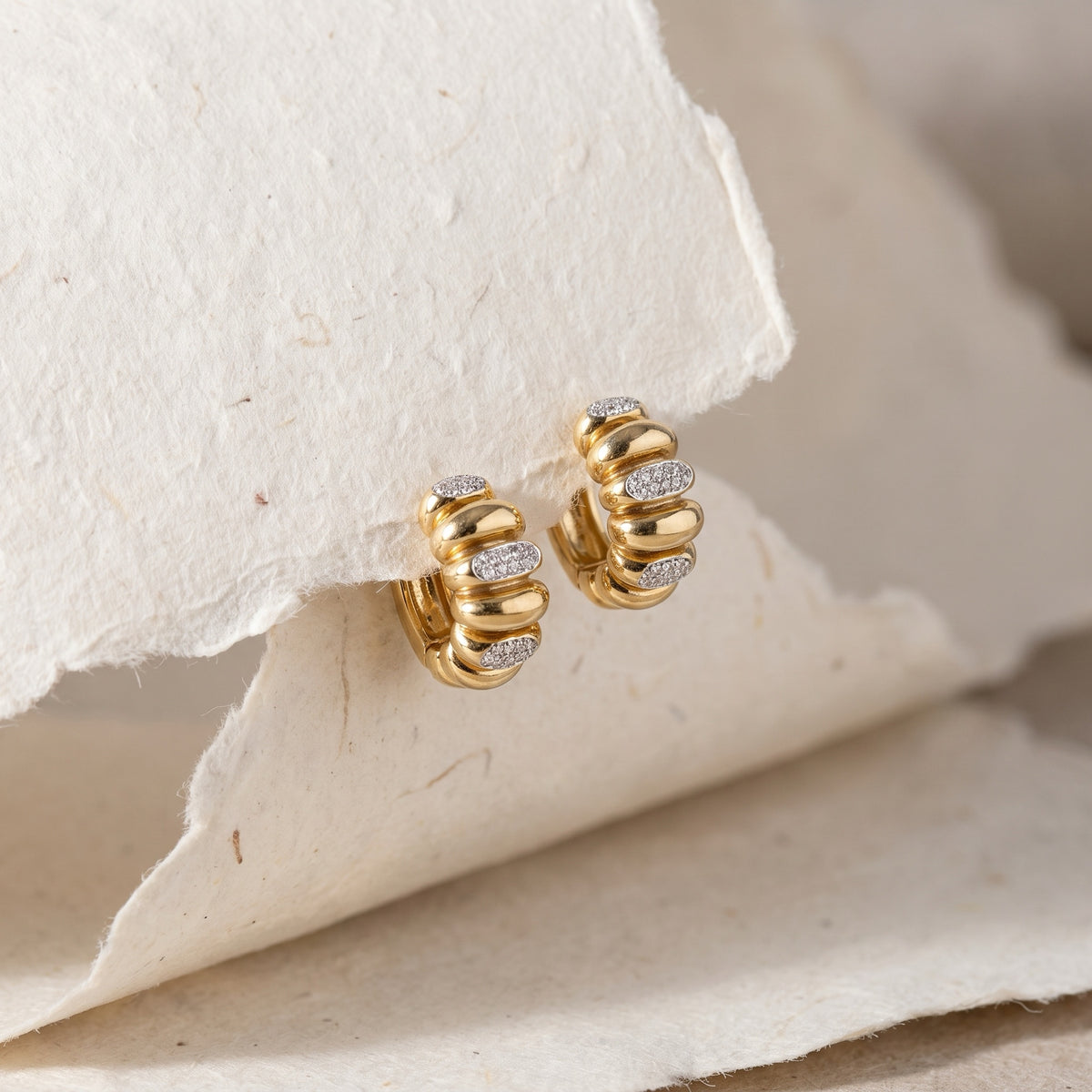 Ribbed diamond huggies on textured paper