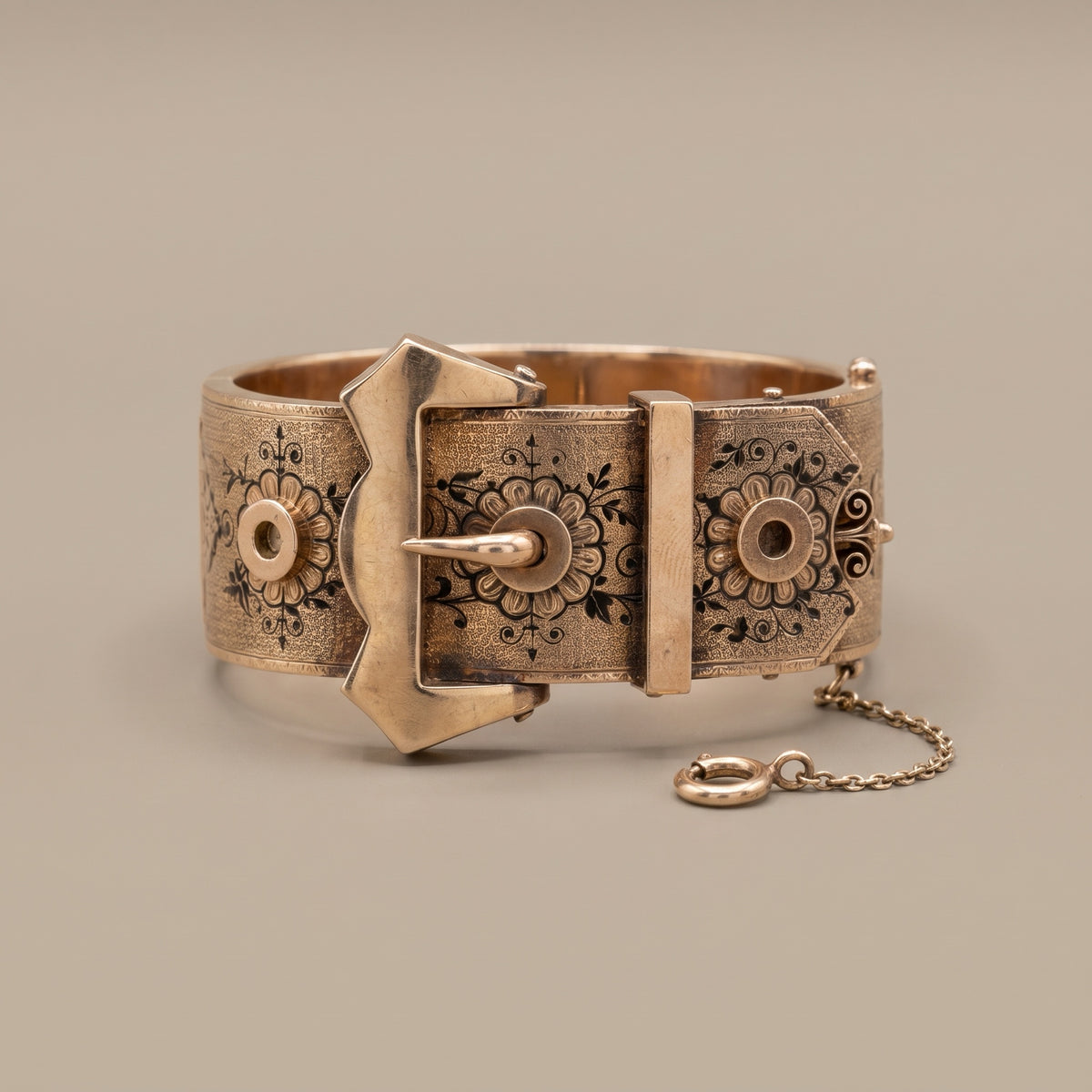 Victorian rose gold buckle bangle with taille d'epargne enamel, studio shot