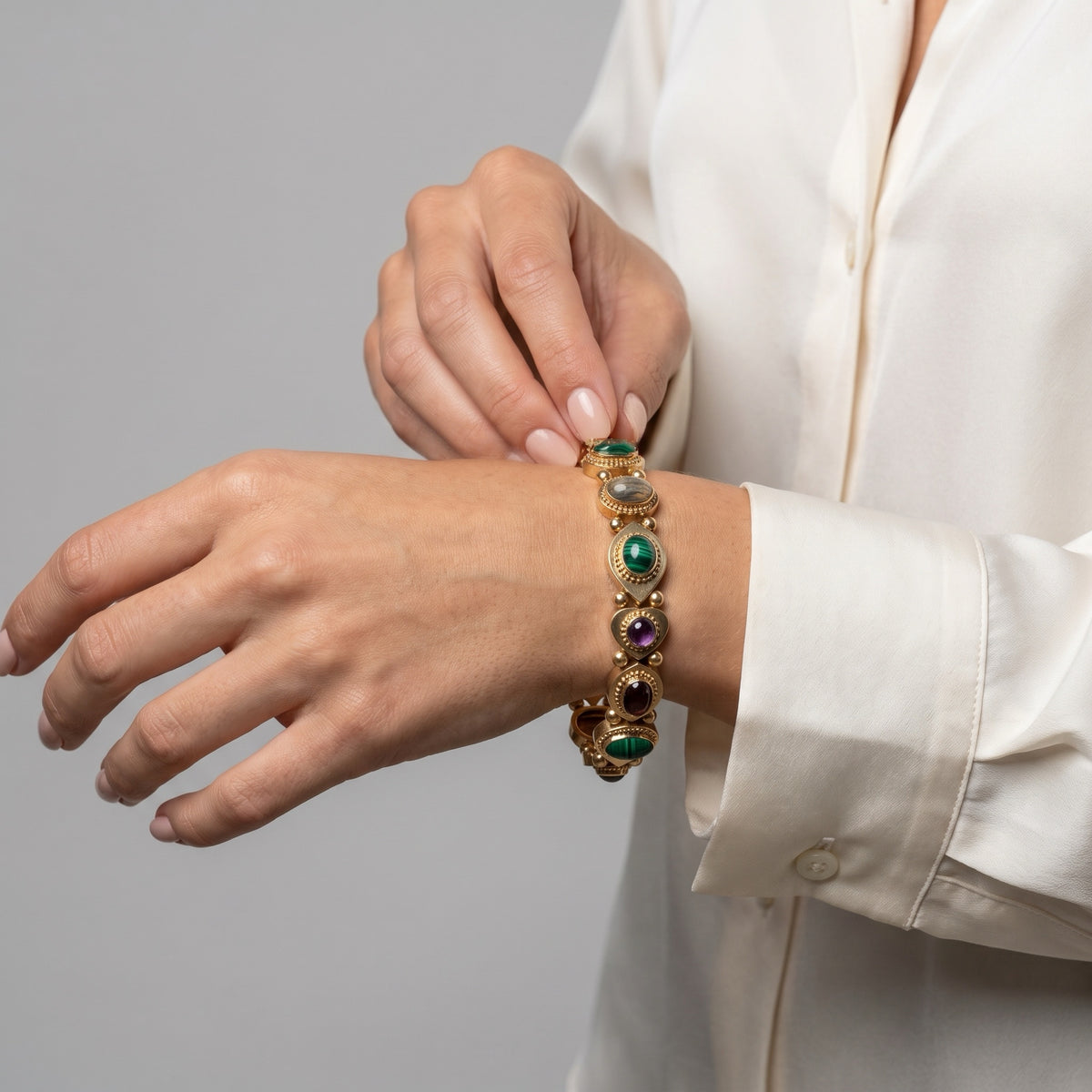 Antique multi-gem slide bracelet worn on the wrist for scale